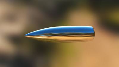 Macro shot of silver bullet caught in flight