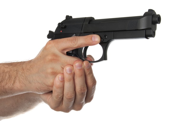 Two hands holding a gun with finger off the trigger on a white background